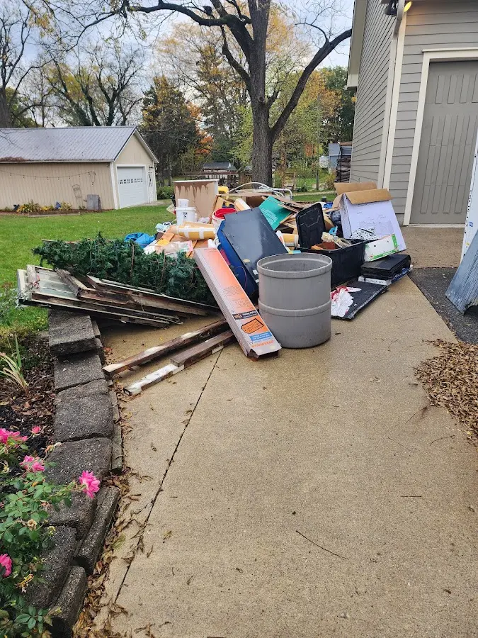 Dumpster being loaded with debris for Roofing Dumpster Rental in Genesee